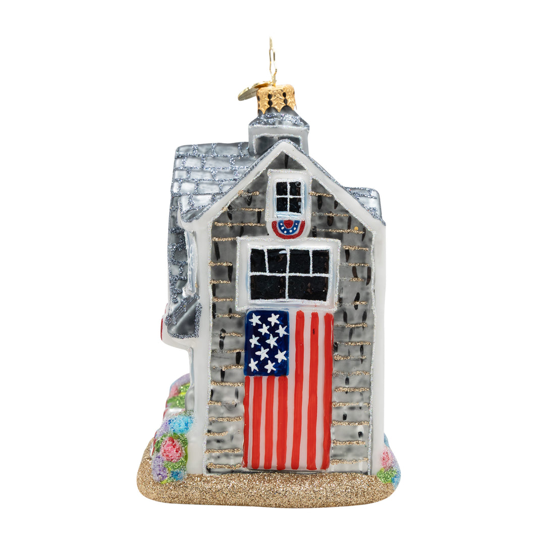 Decorative house ornament with American flag design on a white background