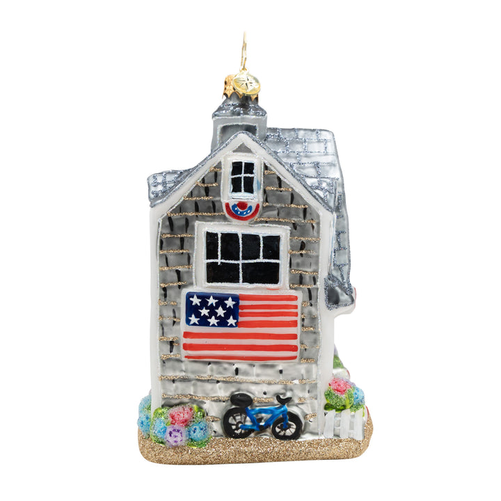 Decorative house ornament with American flag and bicycle on a white background