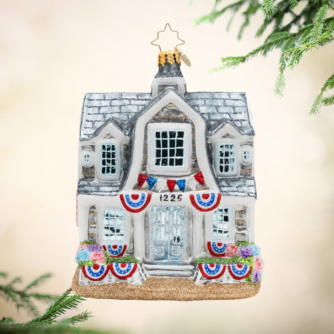 Decorative house ornament with festive decorations on a light background