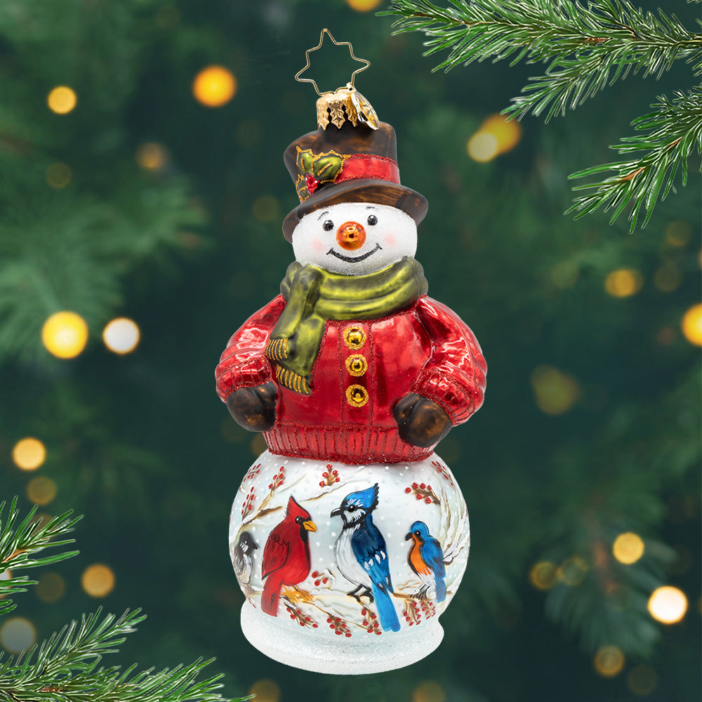 The Chirp Before Christmas. A snowman ornament wearing a red sweater and top hat, with a base decorated with four different birds. View of front.