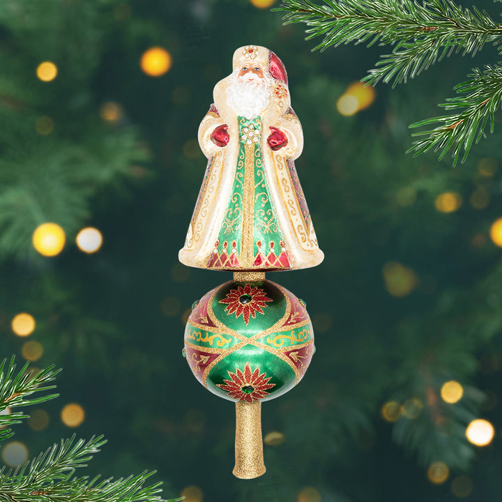 Crown Of Christmas Finial. ornament .A Santa dressed in a white and gold robe on top of a red, green, and gold globe. View of front