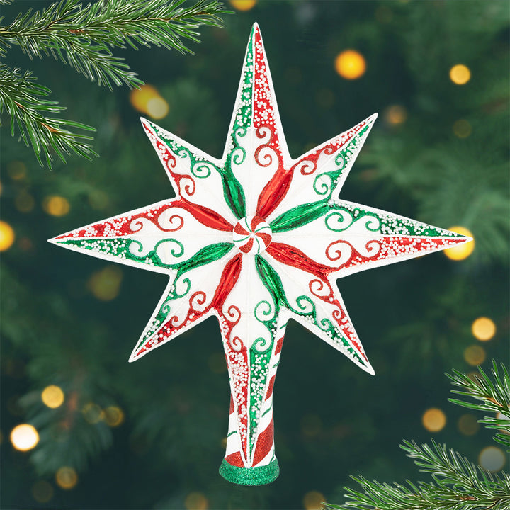 Peppermint Stellar. A white star shaped tree topper with red and green designs and a peppermint in the center. View of front.