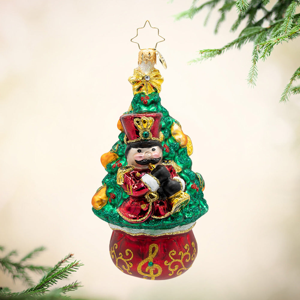 11 Pipers Piping Tree. A bright green Christmas tree ornament with a jolly red piper playing music. View of front