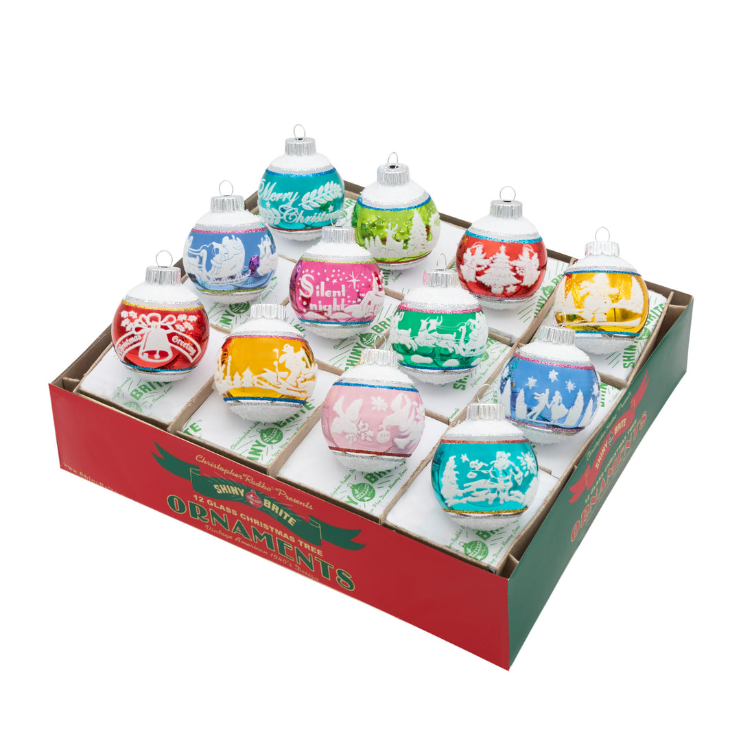 CHRISTMAS CONFETTI 12 COUNT 1.75" SIGNATURE FLOCKED ROUNDS. Twelve round ornaments with big and small stripes in colors of red, blue, teal, pink, and yellow, and each with its own design in white.