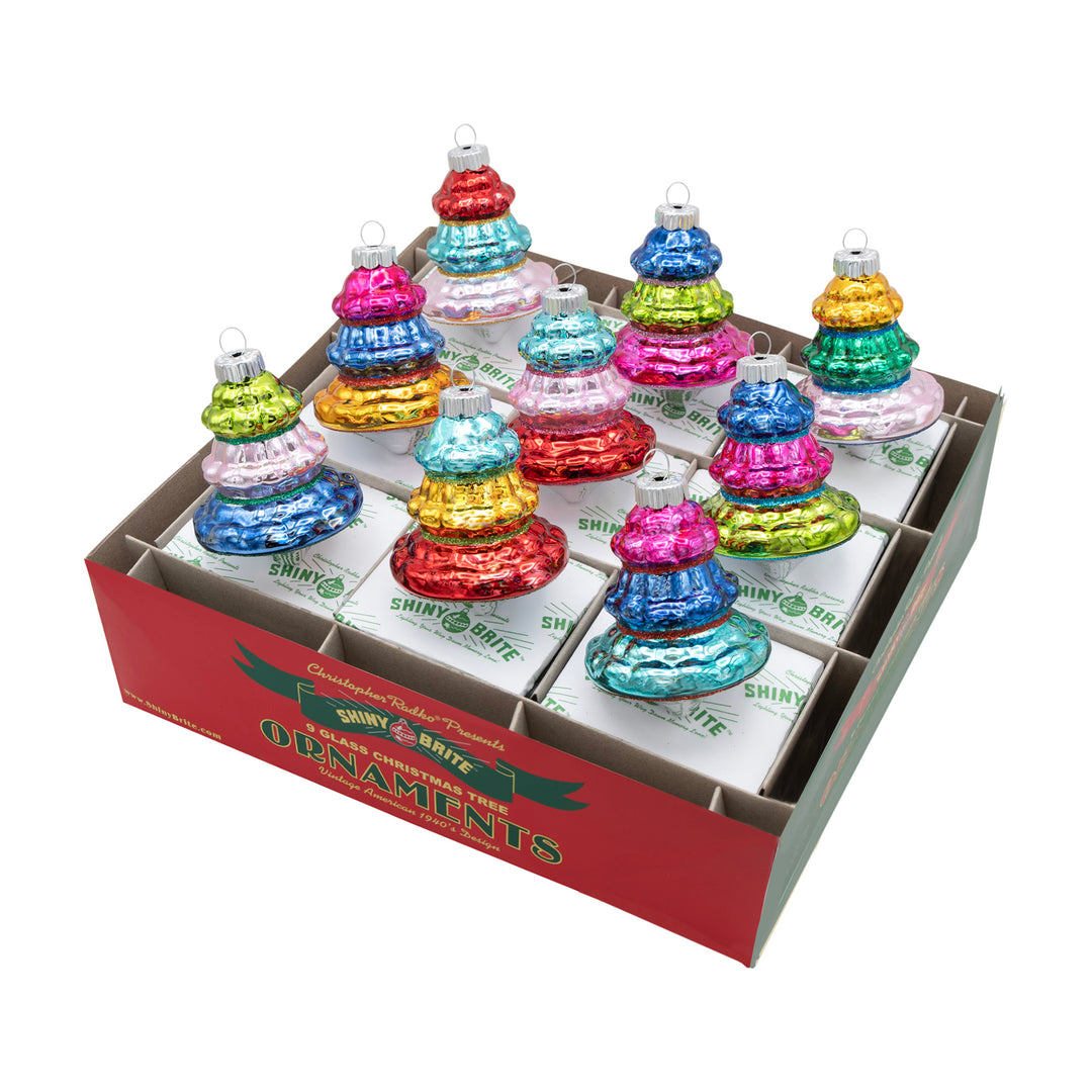 CHRISTMAS CONFETTI 9 COUNT 2.5" SHAPES. Nine tree shaped ornaments in colors of red, green, blue, teal, pink, and yellow.
