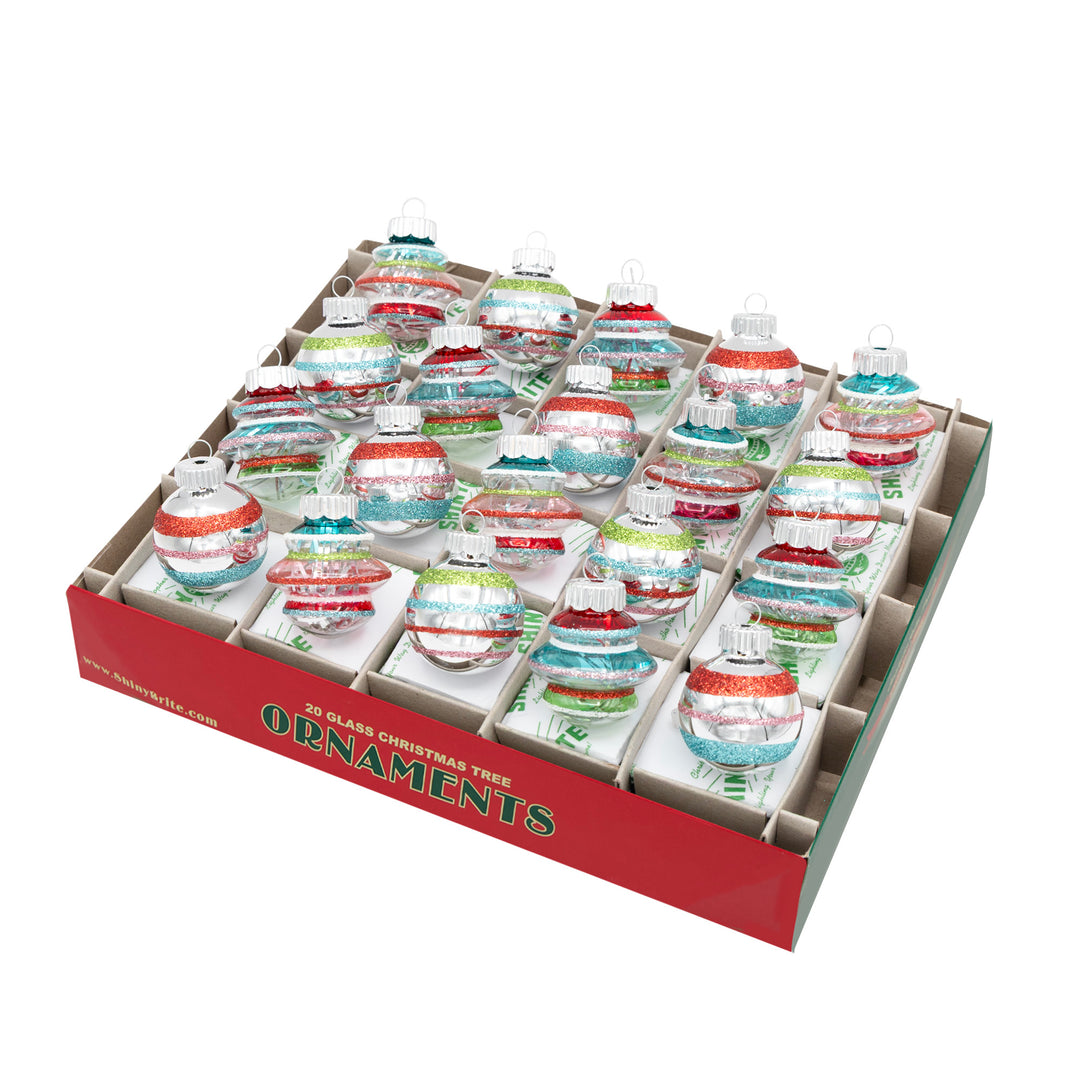 FESTIVE FETE 20 COUNT 1.25" SHAPES & ROUNDS. Ten teardrop that are transparent with silver tinsel inside and colored with red, purple, pink, green, yellow, and blue stripes, and ten round ornaments that are silver with the same-colored stripes.