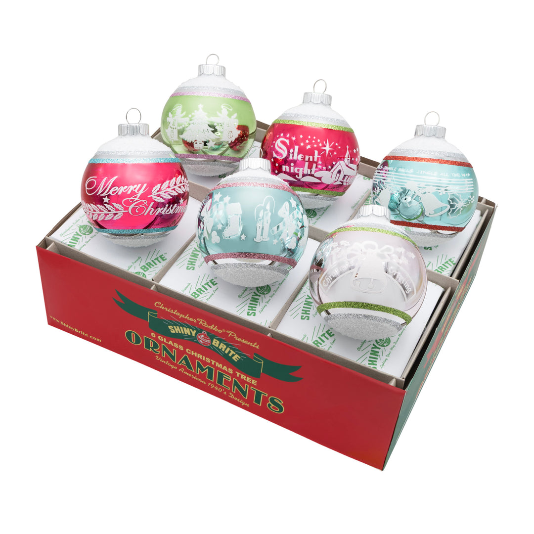 FESTIVE FETE 6 COUNT 3.25" SIGNATURE FLOCKED ROUNDS. Six round ornaments in silver with a big strip in colors of red, green, teal, and silver, each with its own design painted in white.
