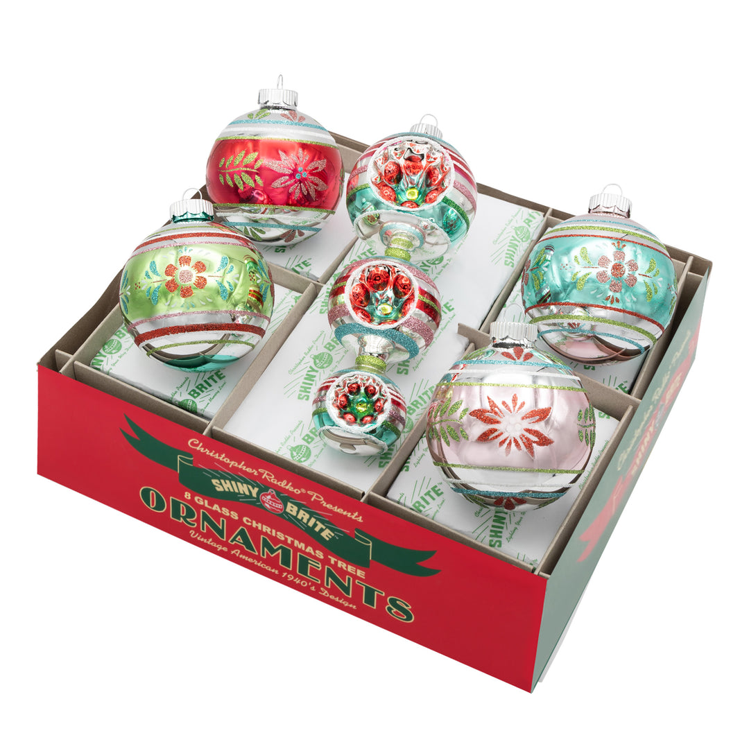 FESTIVE FETE 5 COUNT 3.25” DECORATED ROUNDS & 7” SHAPE. Four round ornaments in silver with stripes and patterns ranging in colors of red, green, teal, and pink, along with an icicle ornament made of three different sized ornaments in the same colors as rounds.