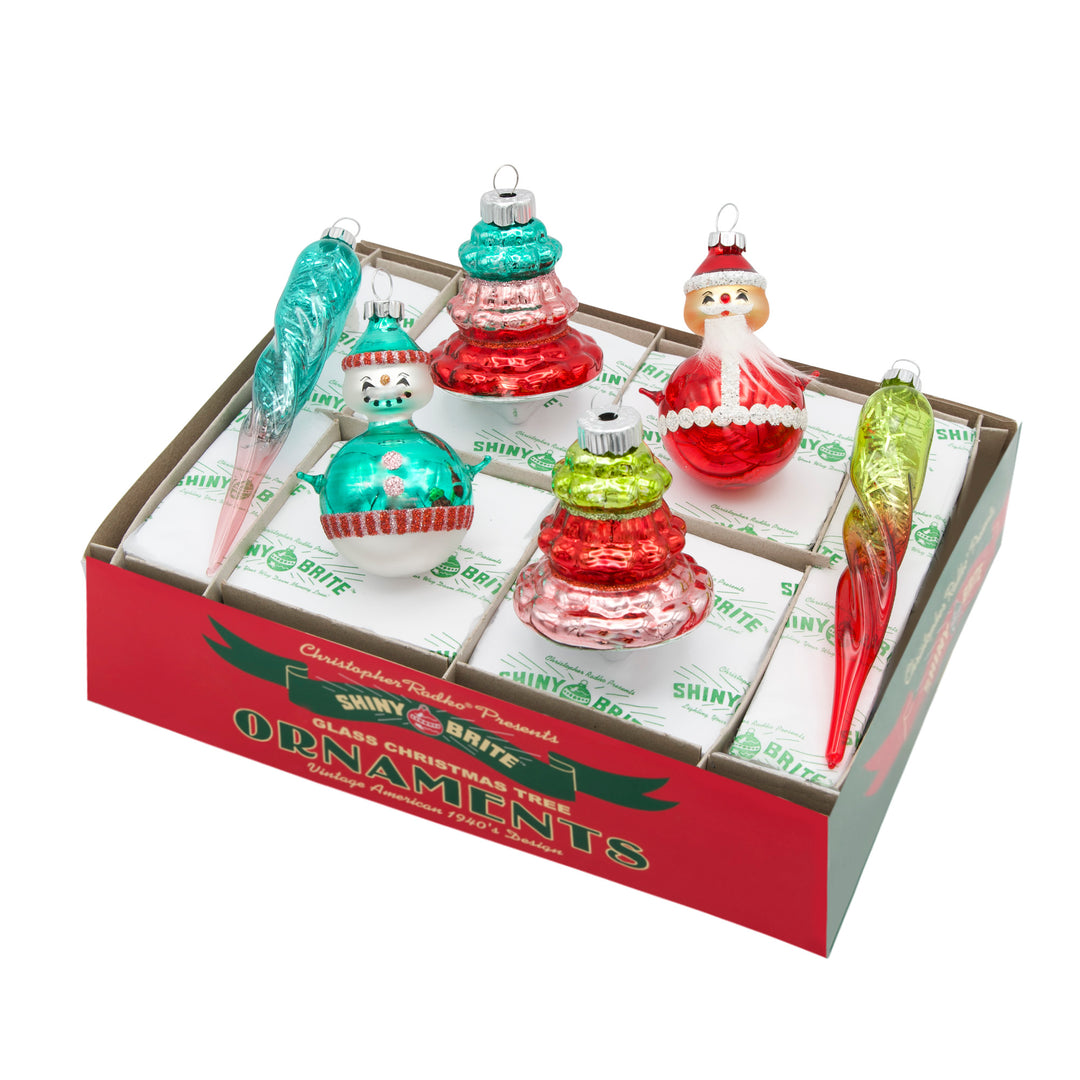FESTIVE FETE 6 COUNT MIXED SHAPES AND FIGURES. Two round ornaments, one of a snowman and the other of Santa, two transparent colored icicles with silver tinsel inside and two Christmas tree shaped ornaments, with all the ornaments ranging in colors of red, green, pink, and teal.