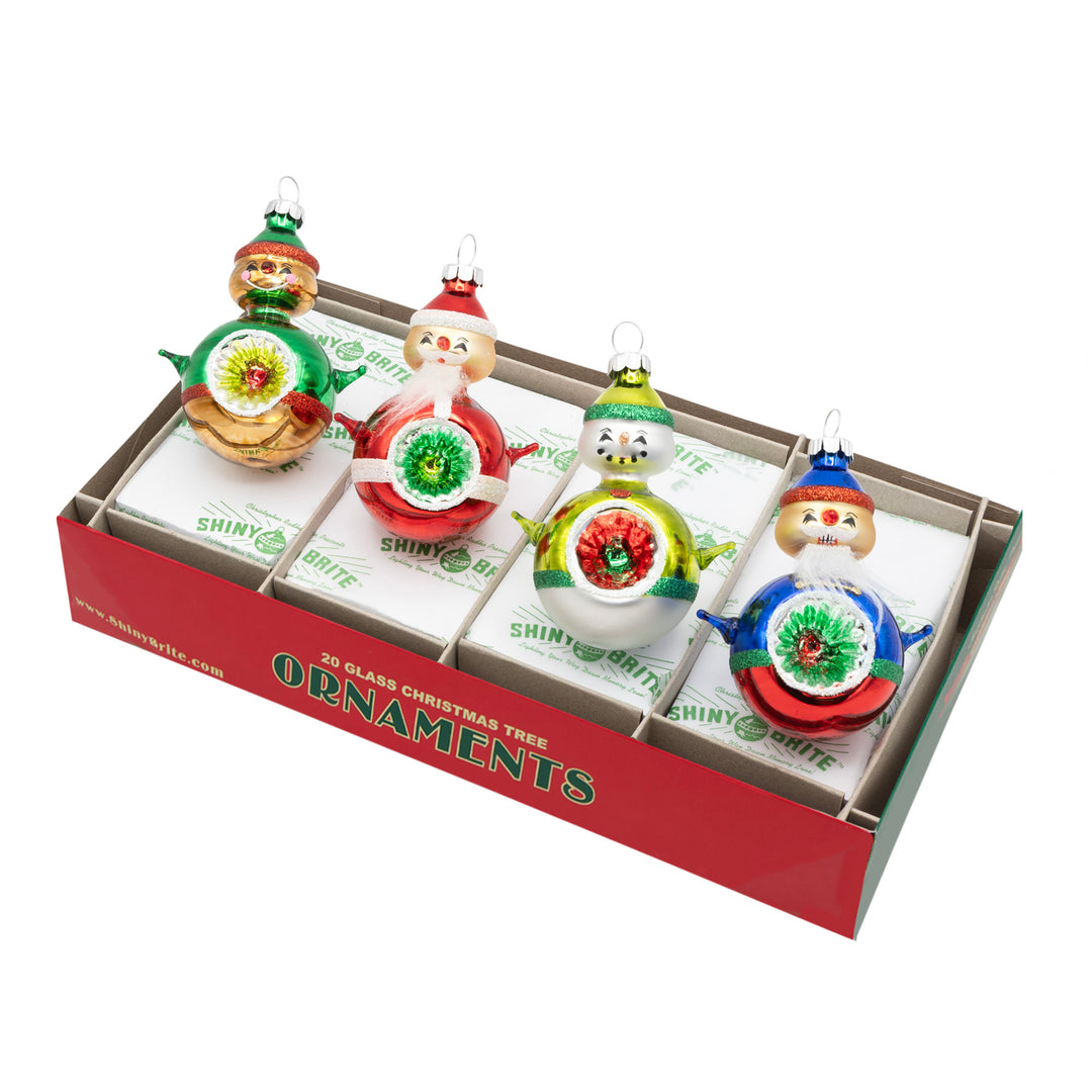 HOLIDAY SPLENDOR 4 COUNT 3.25" REFLECTOR FIGURES. Four round ornaments in shapes of a gingerbread man, snowman, and two Santas, all in colors of red, green, blue, beige.