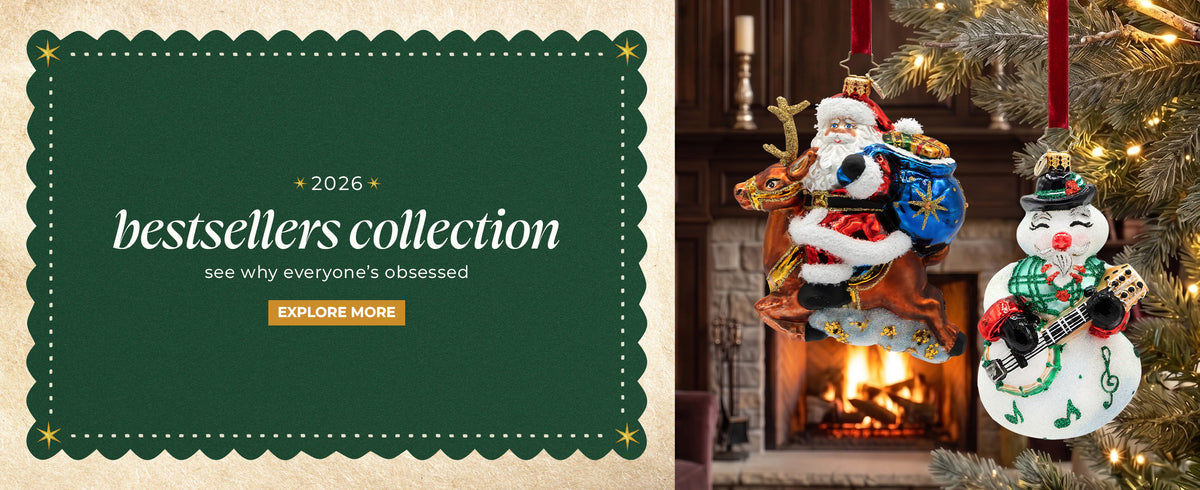 Promotional banner reading "2026 bestsellers collection - see why everyone’s obsessed - EXPLORE MORE" alongside glass Christmas ornaments of Santa riding a reindeer and a musical snowman.