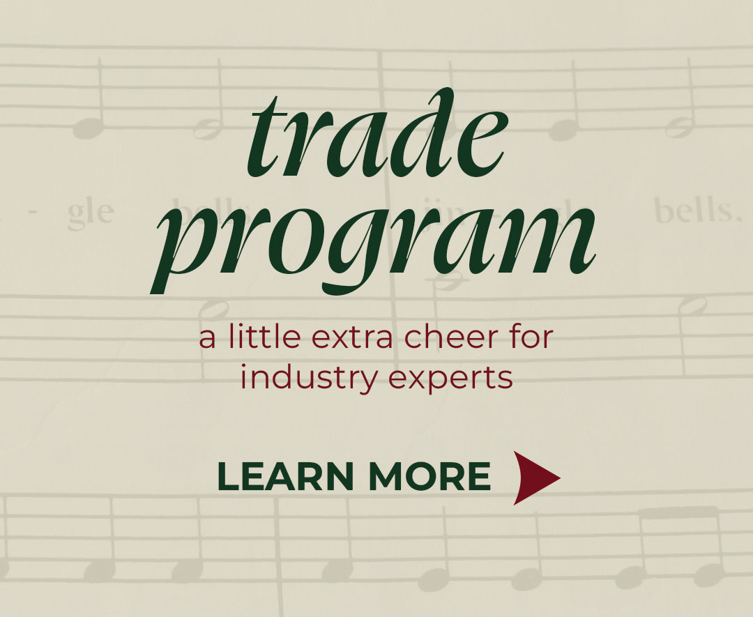 Promotional banner reading "trade program - a little extra cheer for industry experts" with a "LEARN MORE" button over a vintage sheet music background featuring the song "Jingle Bells".