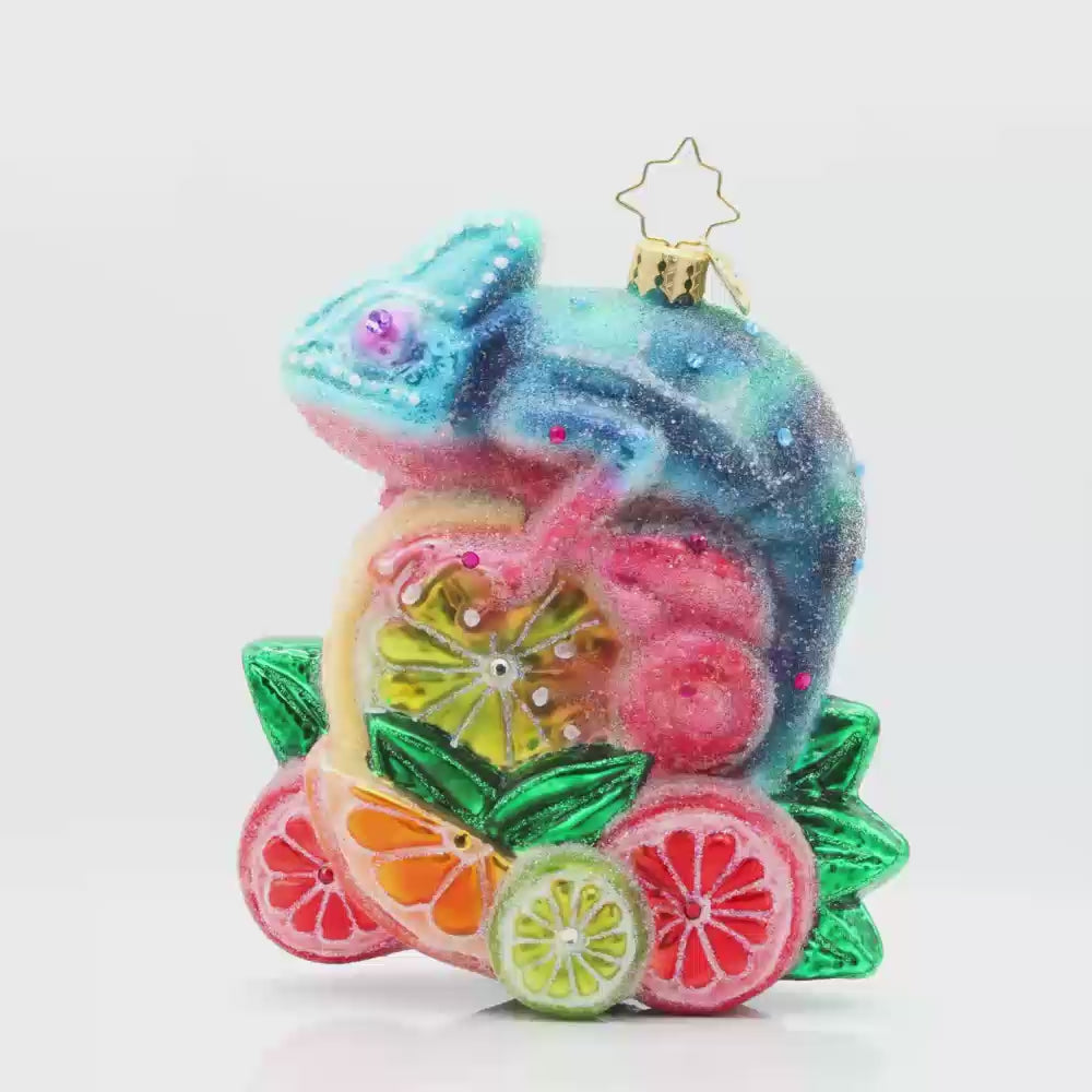 Camouflage Cutie ornament. A chameleon is perched on a vibrant pile of fruit. Video.