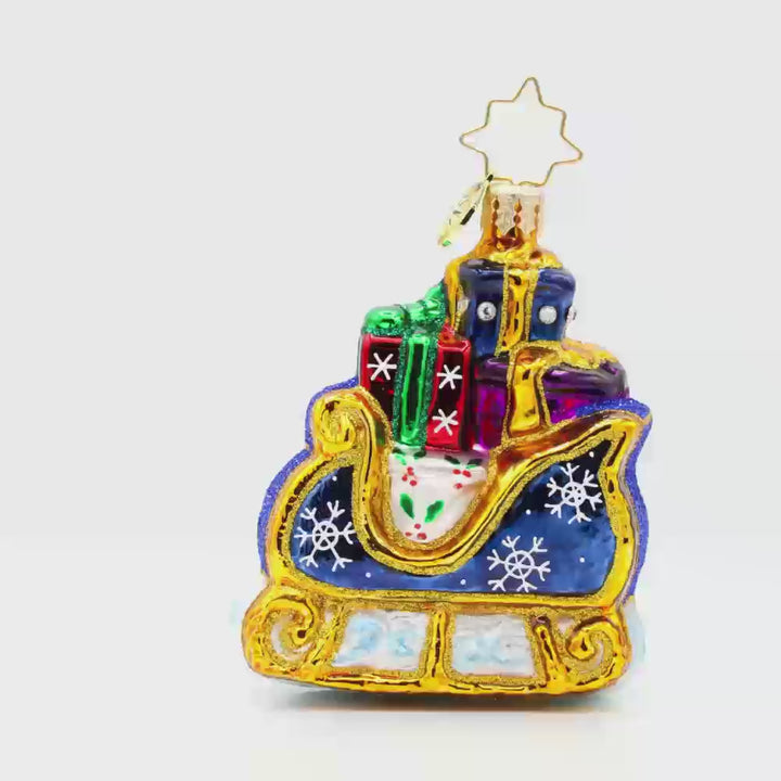 Starry Night Sleigh Gem ornament. A blue sleigh with gold trim, piled high with gifts. Video.