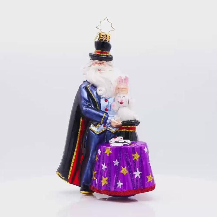 The Merry Magician ornament. Santa features a fluffy beard and cape as he pulls a rabbit out of his sparkling hat. Video.