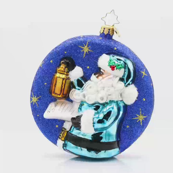 Santa's Guiding Light ornament. Santa wears blue, a "Dear Santa" letter in hand and lantern in the other walking through a starry night. Video.