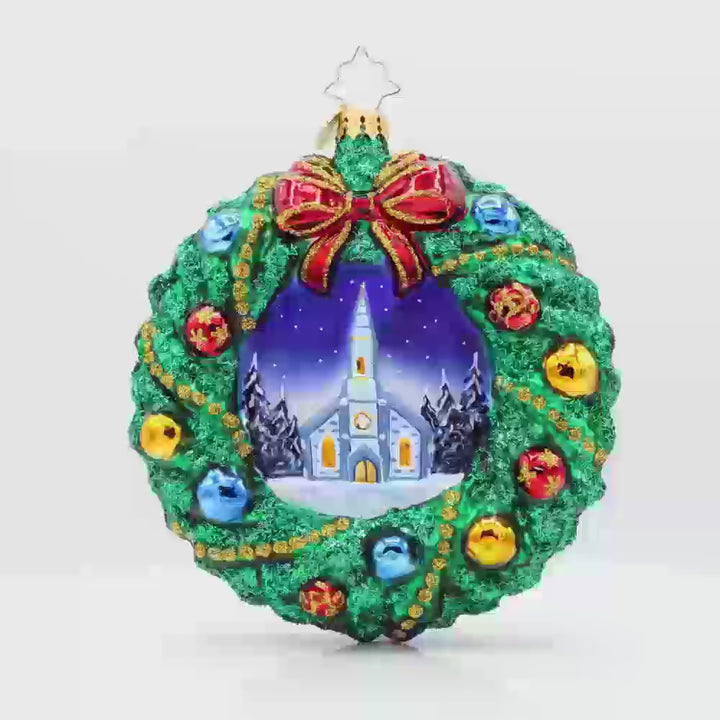 Sacred Harmony Wreath ornament. An elegantly designed wreath, showcasing a charming church in the center. Video.