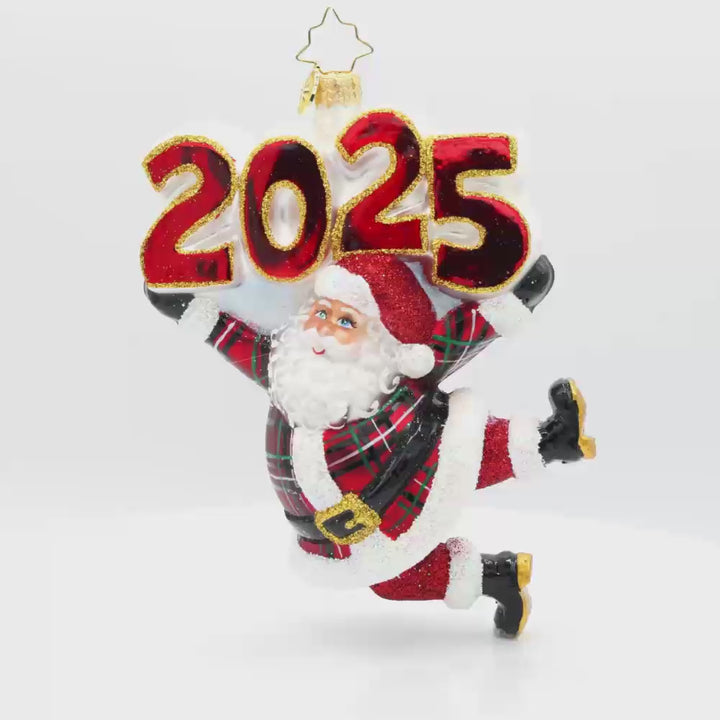 Tartan Time For Fun Ornament. Santa is dressed in a plaid suit, complete with a shiny hat, mittens, and a touch of glitter. "2025" is held above his head in similar colors. Video.