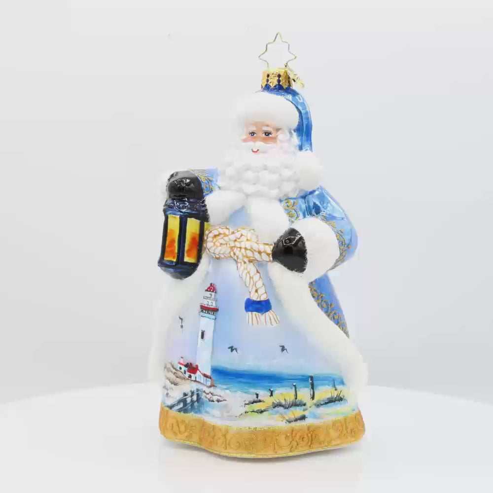 Coastal Claus ornament. Santa dons a blue robe with hand painted lighthouse scene. Video.