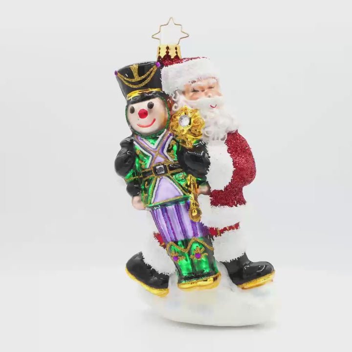 The Christmas Guardian ornament. Santa has a life-size nutcracker in vibrant colors of green, black, purples, and gold. Video.