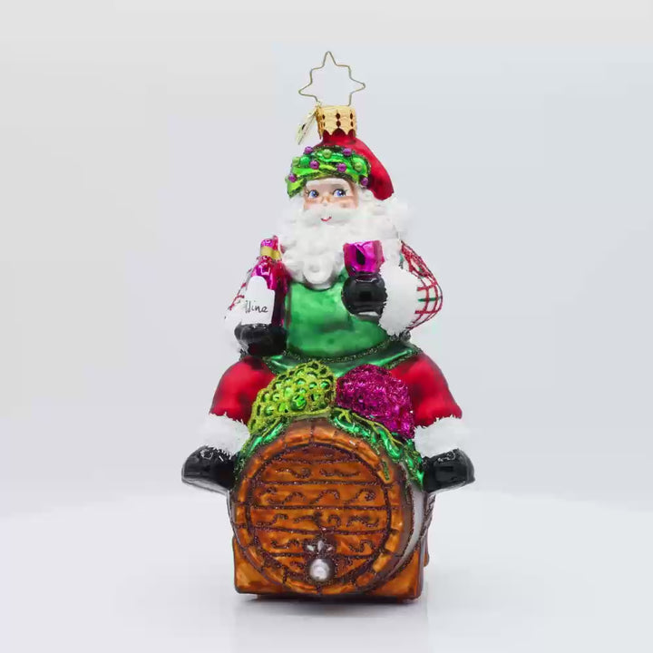 I Believe in Wine Santa ornament. Santa enjoys a glass of wine perched on a barrel. Video.