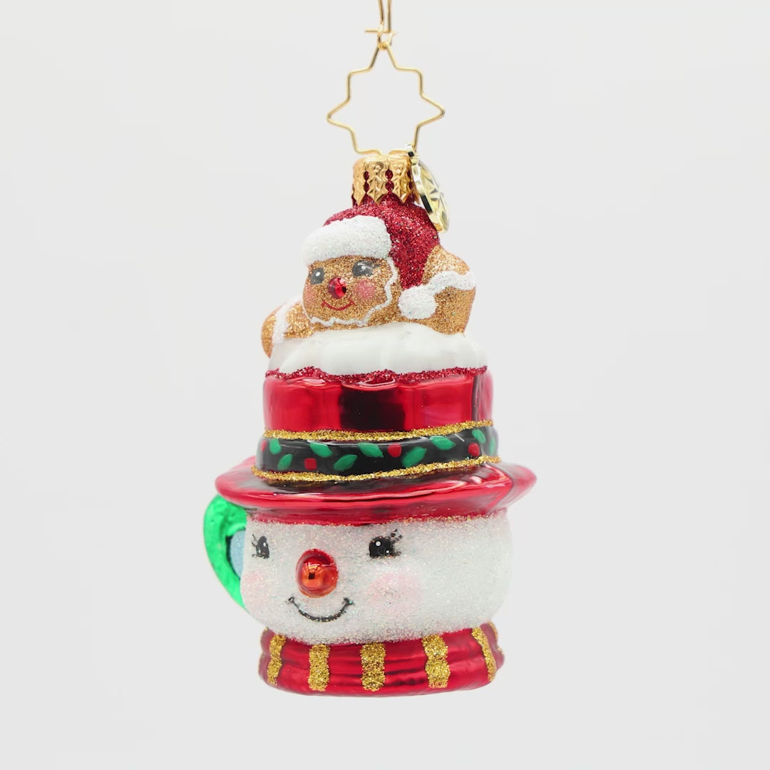 Front view of a snowman ornament shaped like a mug with a  gingerbread man sitting on top of the hat design on a white background