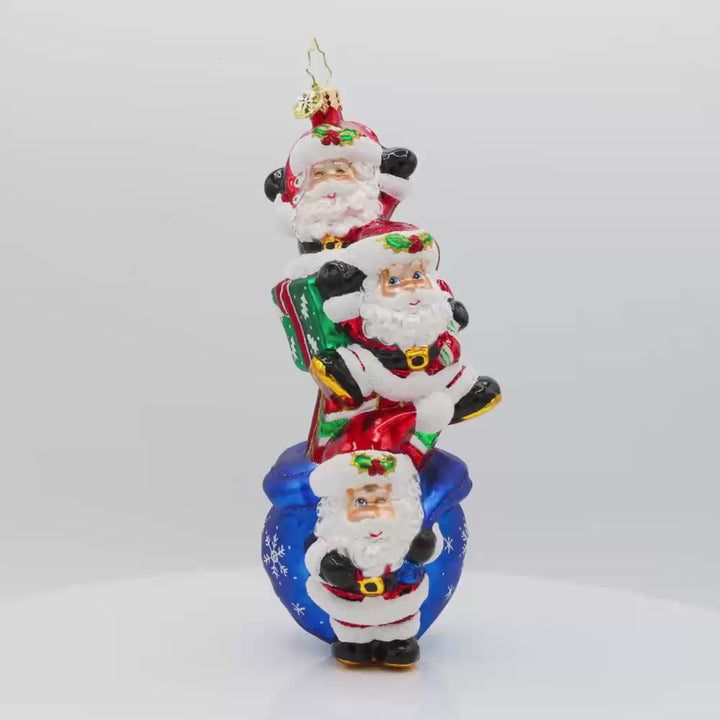 Jolly Santa Trio ornament. With their festive hats, sparkling eyes, and a bag full of gifts. Video.