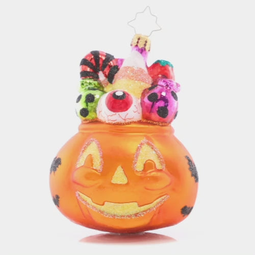 Video - Ornament Description - Trick or Treat Sweets: This ghoulish jack-o-lantern is filled with tricks and treats – take a handful if you dare! This video shows the ornament spinning slowly. 