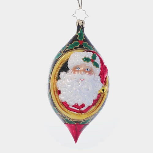 Video - Ornament Description - Holly Jolly Christmas: 'Tis the season! Jolly old Saint Nick smiles from within this intricate drop ornament adorned with festive holly leaves and berries. This video shows the ornament slowly spinning. 