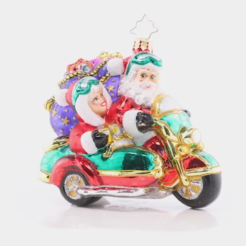 Video - Ornament Description - Santa's Sidecar Sidekick: The Clauses are dressed alike and going for a ride on Santa's Christmas motorbike. It was time to give the reindeer a break from all their delivery hoof aches. This video shows the ornament spinning slowly. 