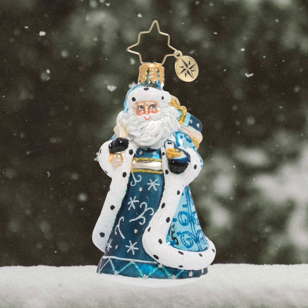 Ornament Description - Debonair Winter Santa Gem: With his bag of gifts in one hand, and a charming chickadee in the other, Santa will weather any storm to get his presents delivered in time for Christmas Eve!