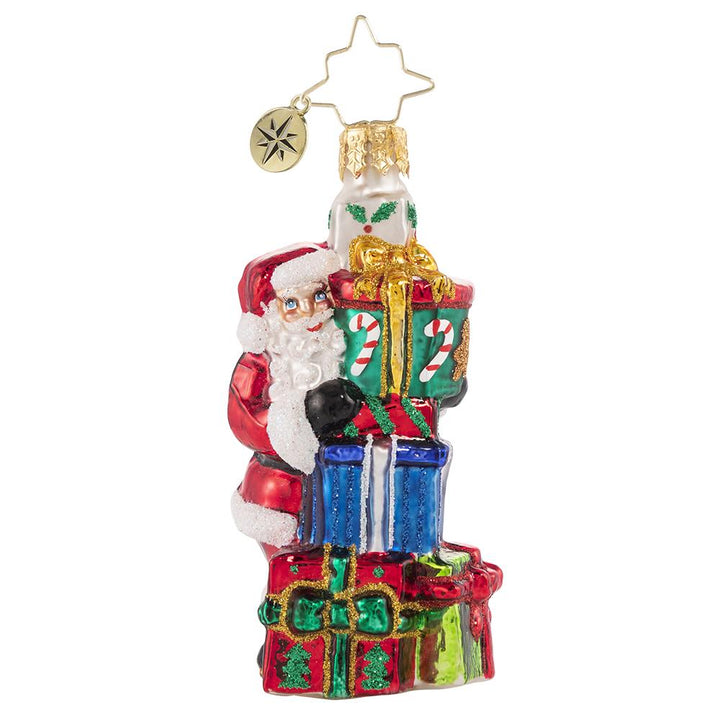 Ornament Description - A Tower of Tidings Gem: Santa sure has his hands full with all these gifts! Luckily after centuries of juggling Christmas responsibilities, he has become an expert at balance! This photo shows the ornament is about 3 inches tall.