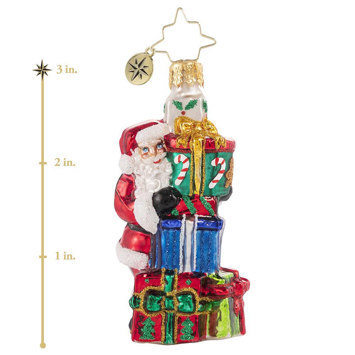 Ornament Description - A Tower of Tidings Gem: Santa sure has his hands full with all these gifts! Luckily after centuries of juggling Christmas responsibilities, he has become an expert at balance! This photo shows the ornament is about 3 inches tall. 