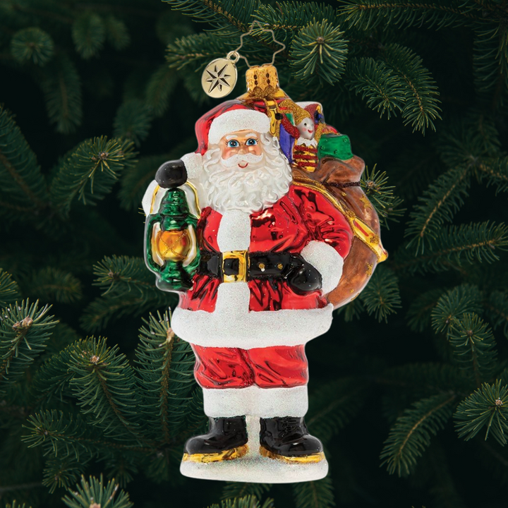 Ornament Description - Our Gallant Guide: The city may be sleeping, but Santa's glowing lantern lights the way as he carries his magic sack of gifts through the darkness of Christmas Eve night.