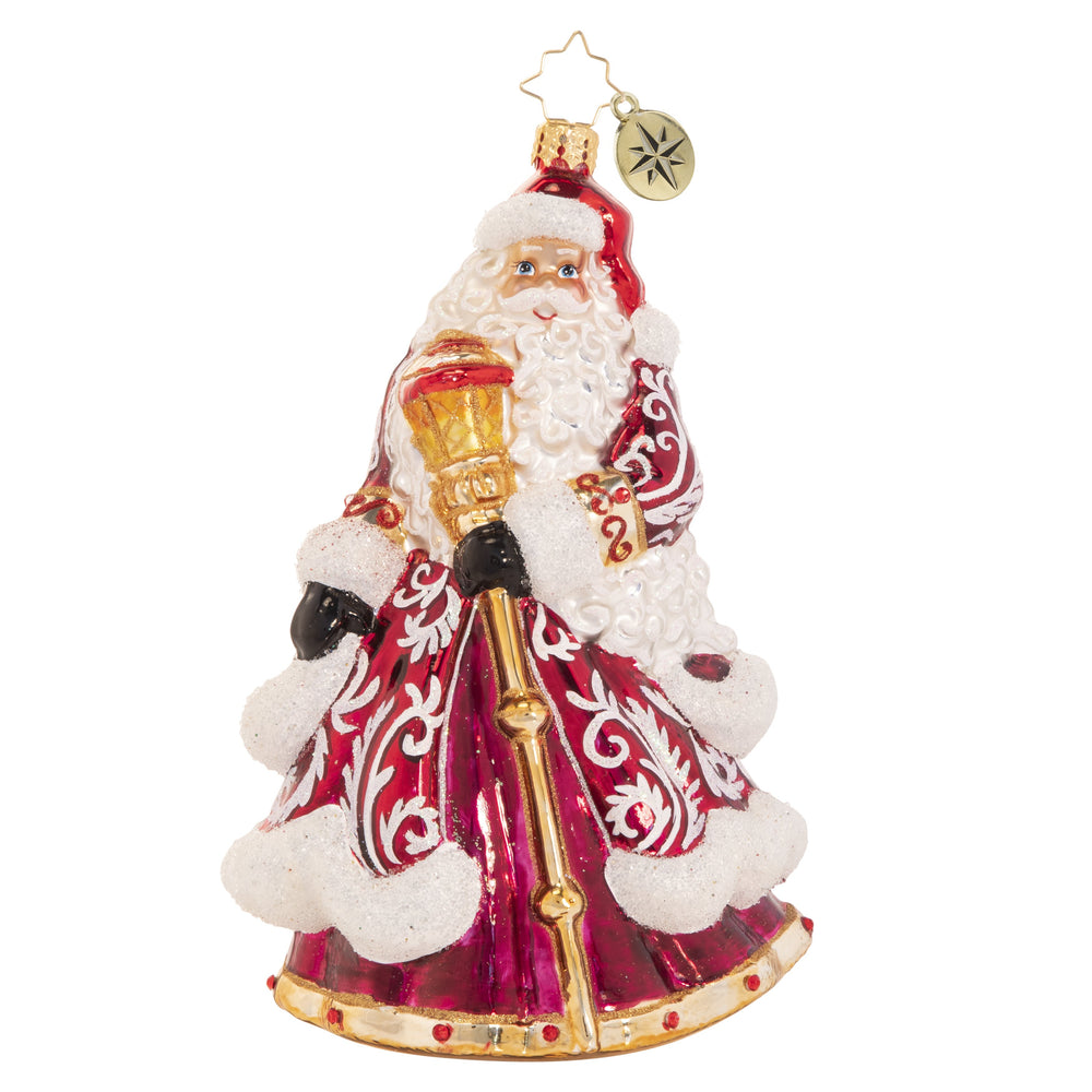 Ornament Description - An En-deering St. Nick: Dressed to the nine(point)s in his favorite reindeer-motif robe, Santa reminisces about Christmases past and honors the trusty animal companions that have made his big night possible for centuries.