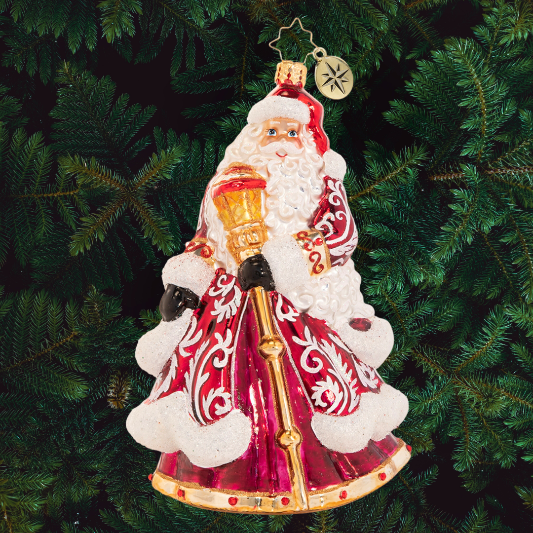 Ornament Description - An En-deering St. Nick: Dressed to the nine(point)s in his favorite reindeer-motif robe, Santa reminisces about Christmases past and honors the trusty animal companions that have made his big night possible for centuries.