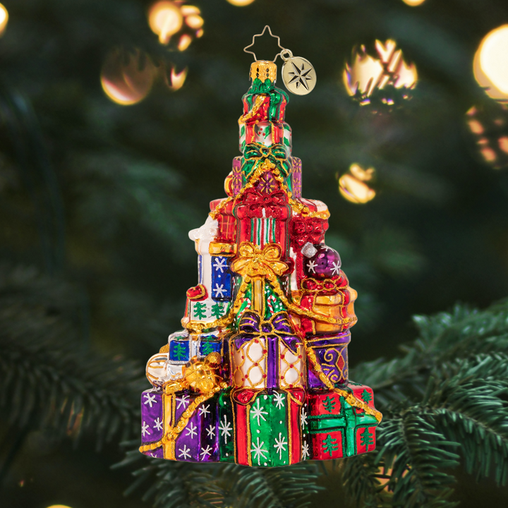 Ornament Description - Abounding Presents: Someone has been VERY good this year! This supersized pile of presents seems to get higher with every Christmas that goes by!