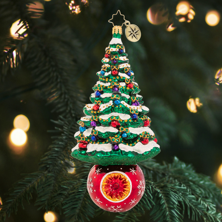 Ornament Description - A Beautifully Balanced Tree: We are pine-ing for Christmas! A frosted fir sits perfectly perched atop a resplendent ruby-red holiday bauble.