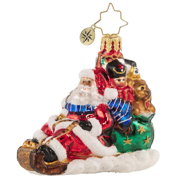 Front - Ornament Description - Timely Toboggan Delivery! Gem: Santa won't let a little thing like air traffic slow him down, so he's ditched the sleigh and taken to the slopes on his trusty toboggan instead. Look out below!