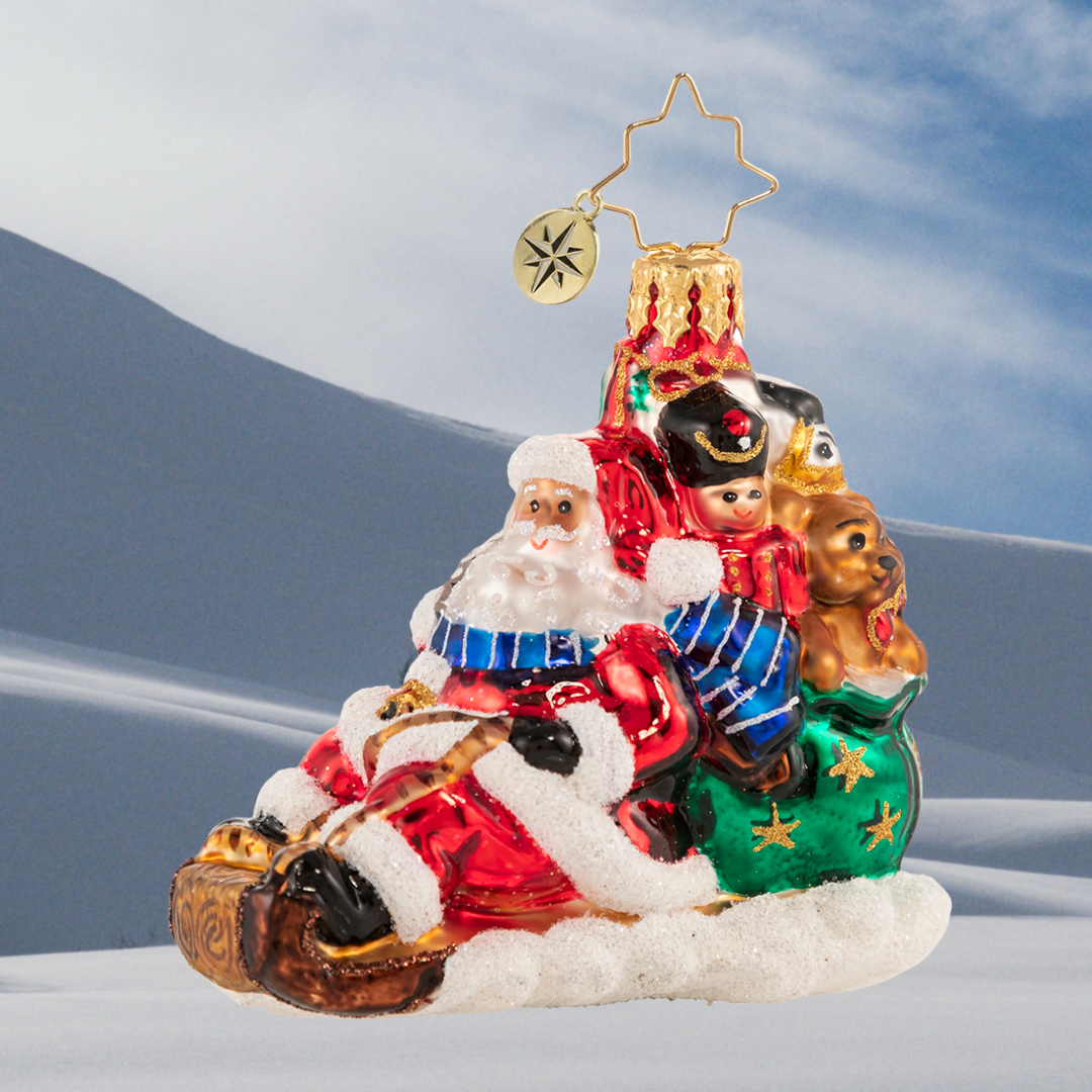 Ornament Description - Timely Toboggan Delivery! Gem: Santa won't let a little thing like air traffic slow him down, so he's ditched the sleigh and taken to the slopes on his trusty toboggan instead. Look out below!