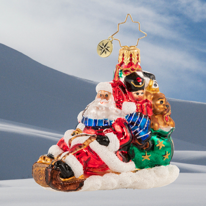 Ornament Description - Timely Toboggan Delivery! Gem: Santa won't let a little thing like air traffic slow him down, so he's ditched the sleigh and taken to the slopes on his trusty toboggan instead. Look out below!