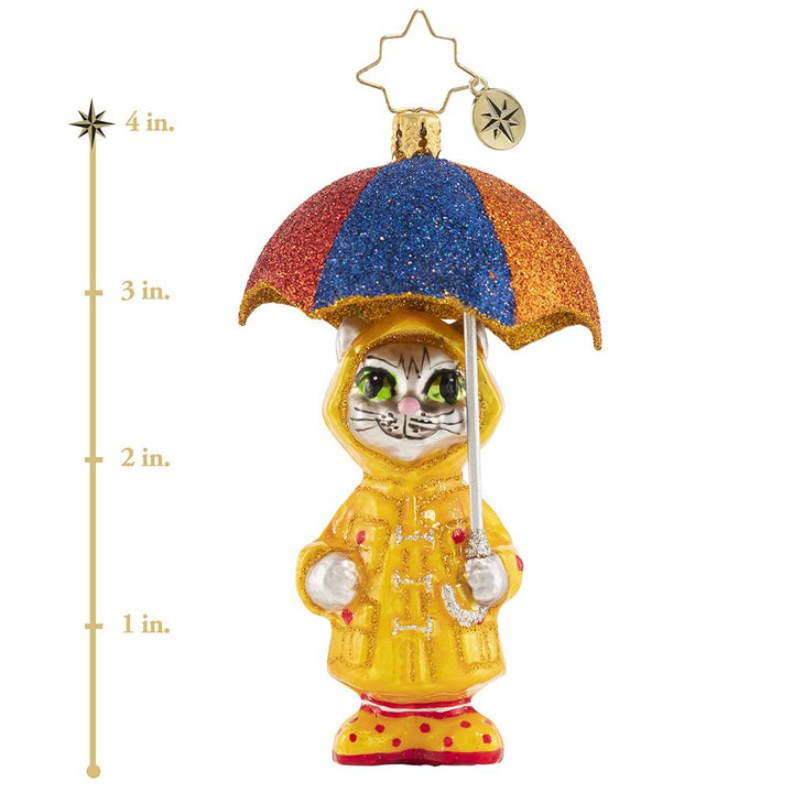 Ornament Description - It's Raining Cats! Gem: This itty bitty kitty has the right idea for staying dry when it is really coming down. Got to love that drizzly-day fashion! This photo shows the ornament is about 4 inches tall.