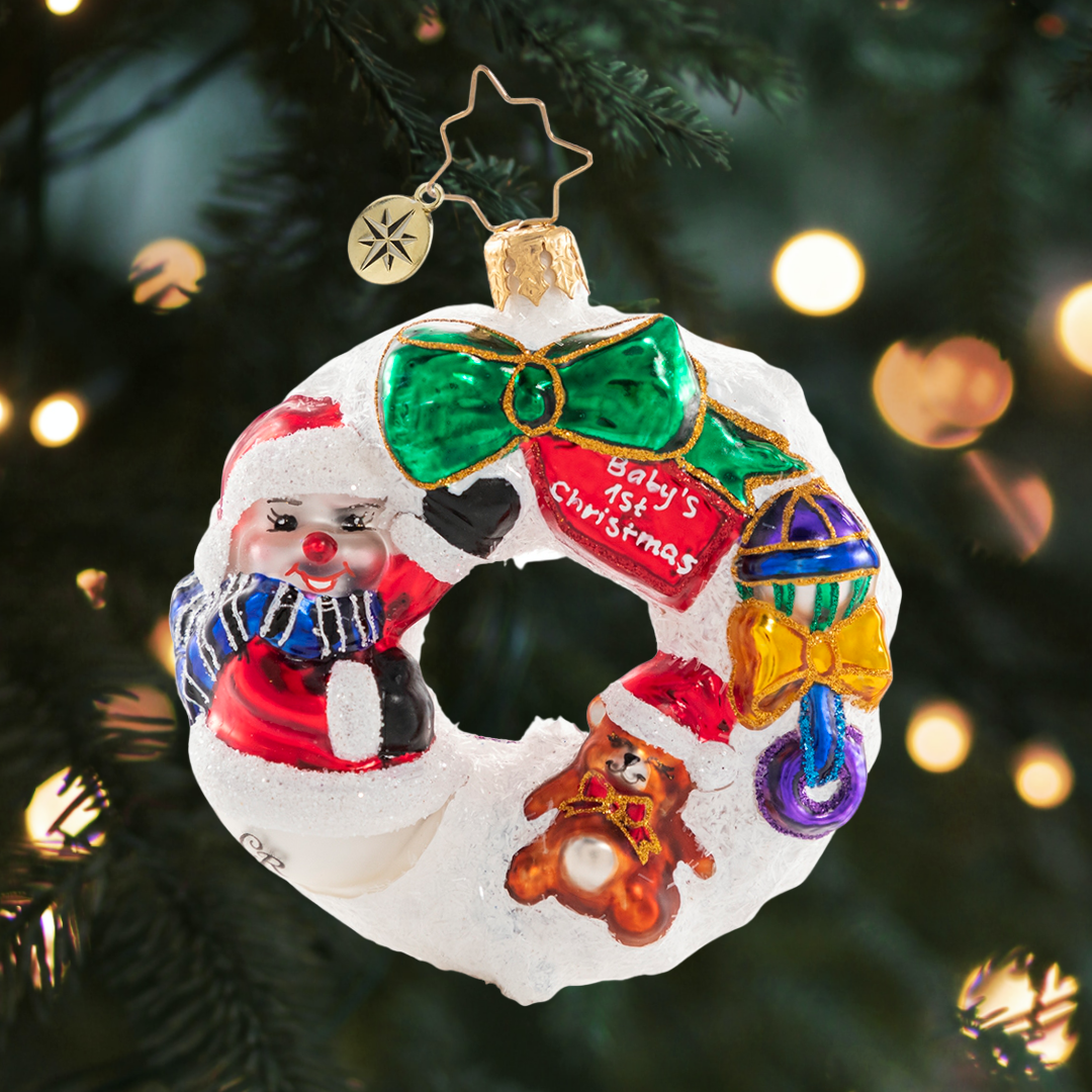 Ornament Description - What Wonders Await Wreath Gem: A baby makes days shorter, nights longer, a home happier, and love stronger. The best is yet to come! Dedicate your newest arrival with this wee wreath of wonders!
