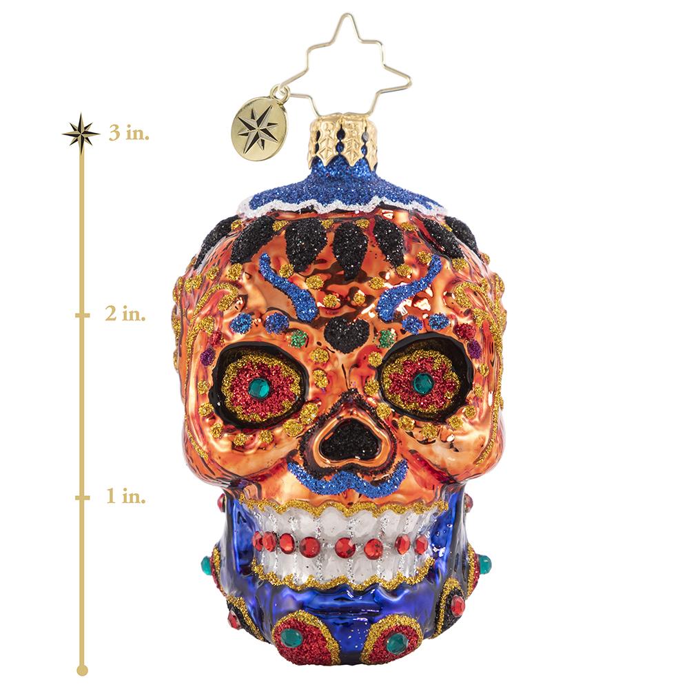 Ornament Description - Color Calavera Gem: This itty bitty sugar skull knows how to stand out from the crowd. Adorned with jewels and sparkle he makes his culture proud! This photo shows the ornament stands about 3 inches tall.