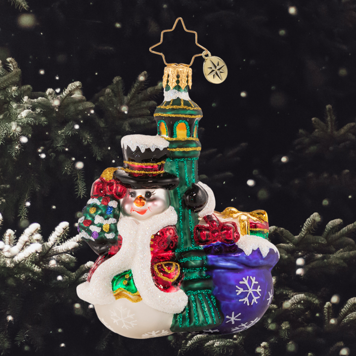 Ornament Description - Swinging In The Rain Gem: Everyone's favorite snowman is turning heads in town. Each light pole that he passes, he cannot resist a little swing around!