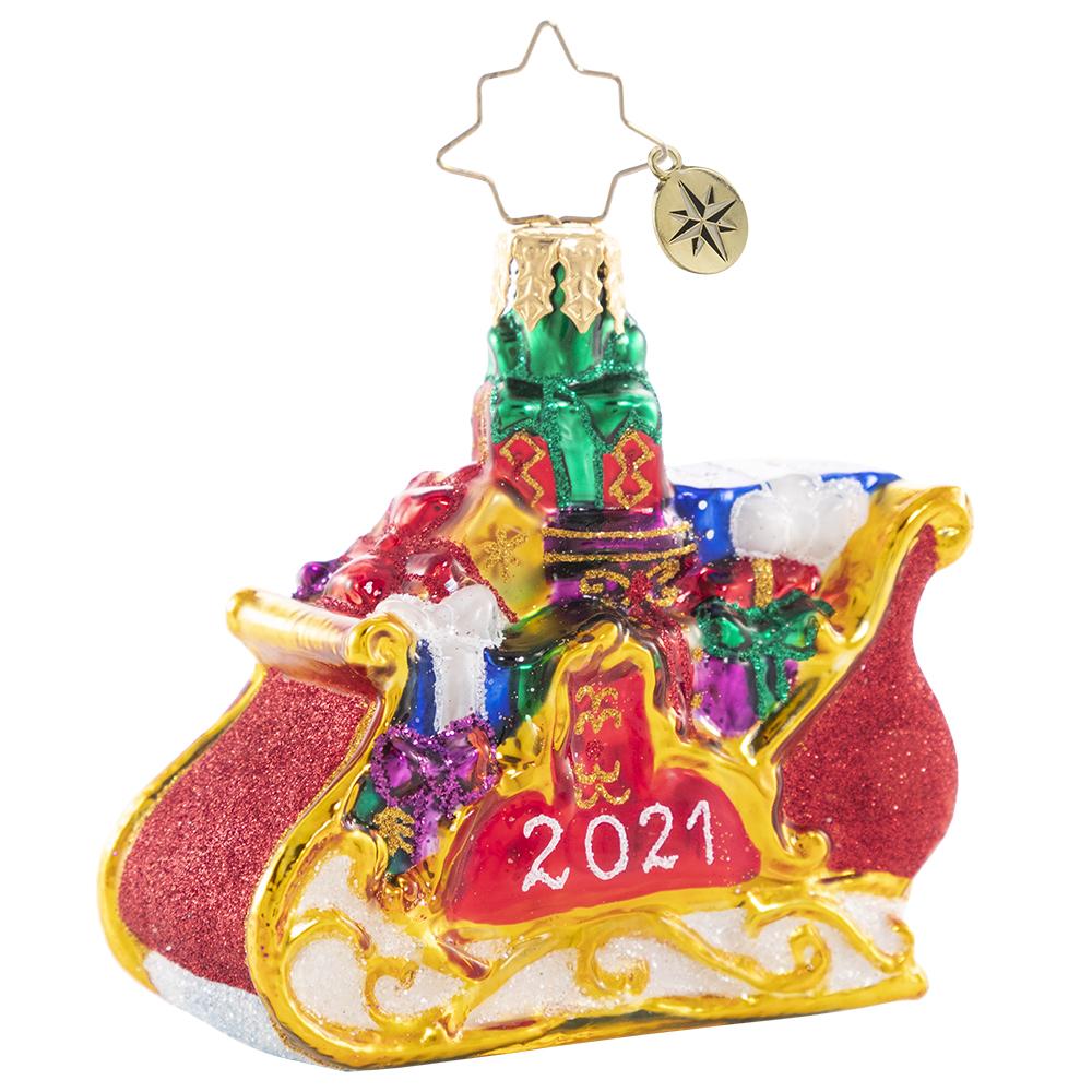 Ornament Description - Precious Cargo 2021 Gem: Ready for takeoff! He has made his list and checked it twice--now the elves have packed up Santa's miniature sleigh in preparation for the biggest night of the year!