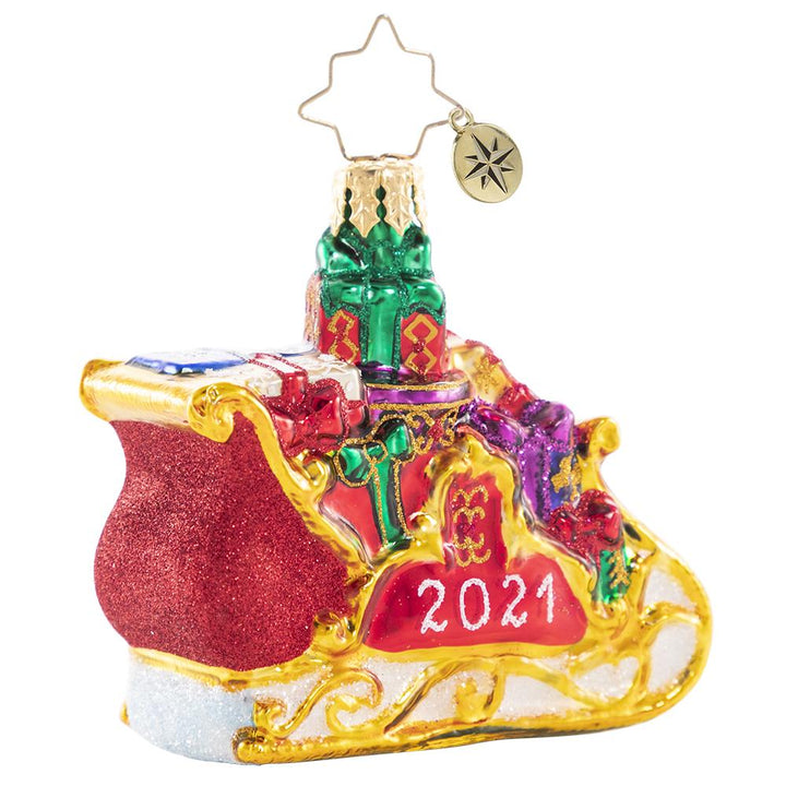 Back - Ornament Description - Precious Cargo 2021 Gem: Ready for takeoff! He has made his list and checked it twice--now the elves have packed up Santa's miniature sleigh in preparation for the biggest night of the year!
