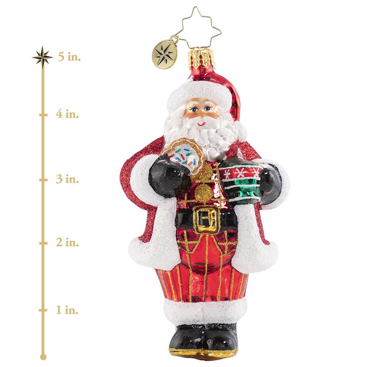 Ornament Description - Cocoa Cravings Claus: There is nothing quite like a creamy cup of hot cocoa to warm up after a snowy night's work at the North Pole. Santa knows it always tastes better out of his favorite holiday cup and with one of Mrs. Claus's freshly baked sugar cookies on the side! This photo shows the ornament is about 5 inshes tall.