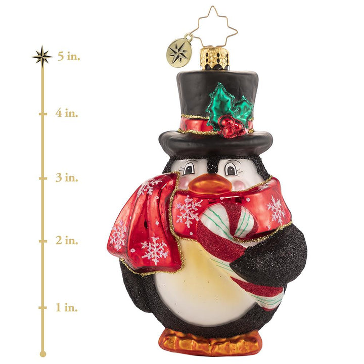 Ornament Description - Flightless Yet Fashionable: He may not be able to fly, but this bird sure has style! Mr. Penguin waddles into our hearts in his festive scarf and top hat, snacking on his favorite tasty treat! This photo shows the ornament is about 5 inches tall. Ornaments - Description: Flightless Yet Fashionable - He may not be able to fly, but this bird sure has style! Mr. Penguin waddles into our hearts in his festive scarf and top hat, snacking on his favorite tasty treat! 