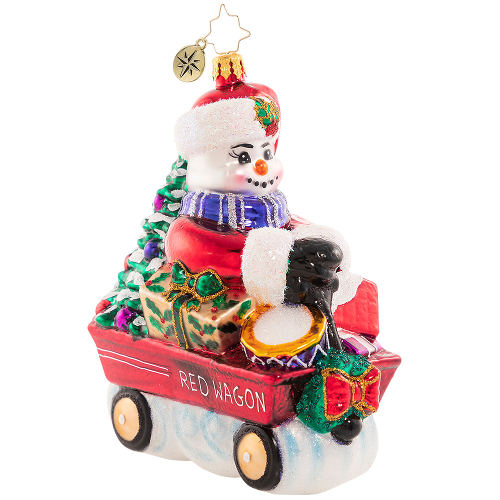 Front-Side View: Ornament Description - Wheelin' And Dealin' Snowman: Look at Frosty go! He is wheel-y excited for Christmas and is thumpity-thumping through town in his little red wagon. We hope he got insurance!